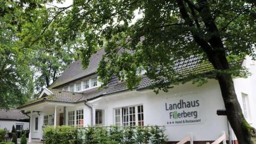 a white building with a sign on it at Landhaus Fillerberg in Wildeshausen