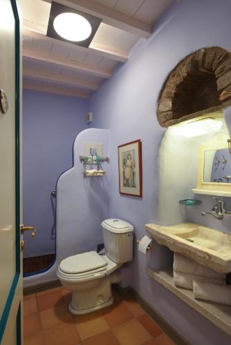 a bathroom with a toilet and a sink at Tinos Grand Villa 6BR 15ppl Infinite Views in Triandáros