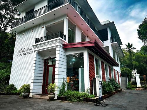 a store front of a white building at Sisila Inn & Restaurant in Warakapola