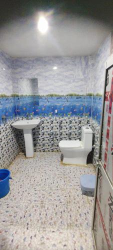 a bathroom with a sink and a toilet at Geetasheel Palace in Naimishāranya