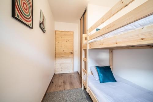 a couple of bunk beds in a room at Apartment Thredbo, Les Carroz d'Arâches - by EMERALD STAY in Arâches-la-Frasse