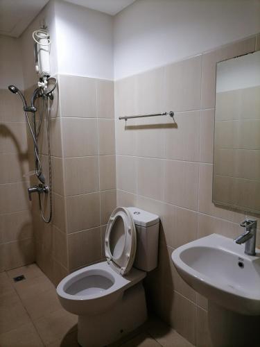 a bathroom with a toilet and a sink at Roxas Blvd Stunning Studio Condo Near US Embassy in Manila