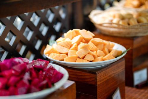 two bowls of fruit on a table with other bowls of food at Khemara Angkor Hotel & Spa in Siem Reap