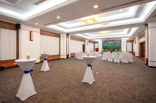 a banquet hall with white tables and white chairs at Khemara Angkor Hotel & Spa in Siem Reap