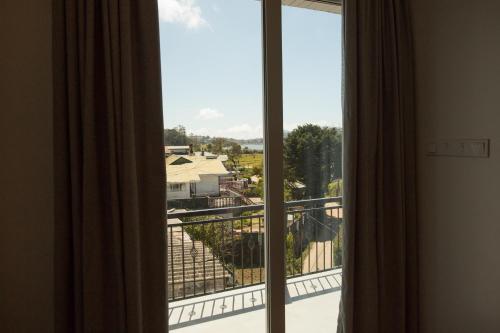 a room with a view of a balcony at Hotel Grand Turf By GSP in Nuwara Eliya