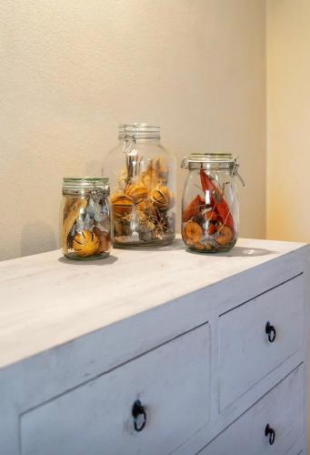 three jars filled with fruit and vegetables on a counter at Wp Relais apartments in Diso