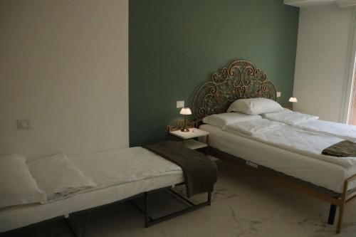 a bedroom with a bed and a bench in it at Domus Aurus Luxury in Bardolino