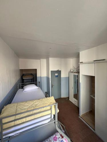 a small room with a bed and a bathroom at Hotel THEFFA in Marseille