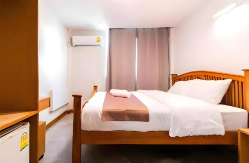 a bedroom with a bed with white sheets at XX GO INN Khaosan - โกอินน์ ถนนข้าวสาร in Bangkok