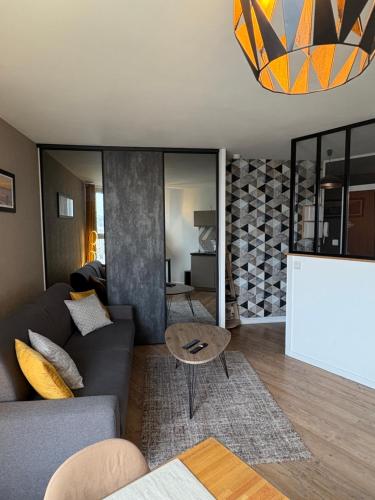 a living room with a couch and a table at Vivez Le Havre ! Studio en Résidence bord de mer - Port de plaisance - 3 Etoiles in Le Havre
