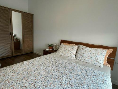a bedroom with a large bed with two pillows at Swanbay Heaven in Nhơn Trạch