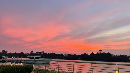 a boat is docked in a lake at sunset at Swanbay Heaven in Nhơn Trạch