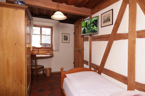 a bedroom with a bed and a desk in a room at Hotel und Gasthof Ritter St. Georg in Erlangen