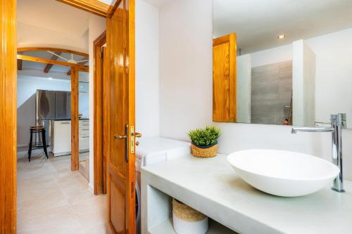 a bathroom with a white sink and a mirror at Villa Carla in Port de Soller
