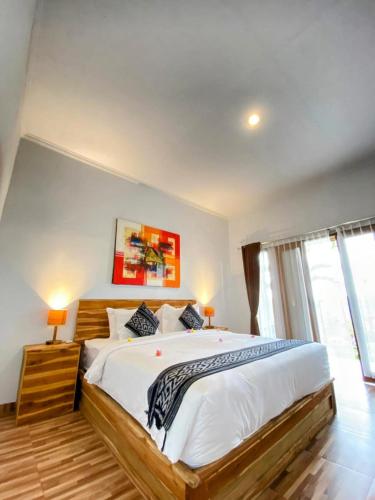 a bedroom with a large bed in a room at Green Sunrise Hill View in Nusa Penida