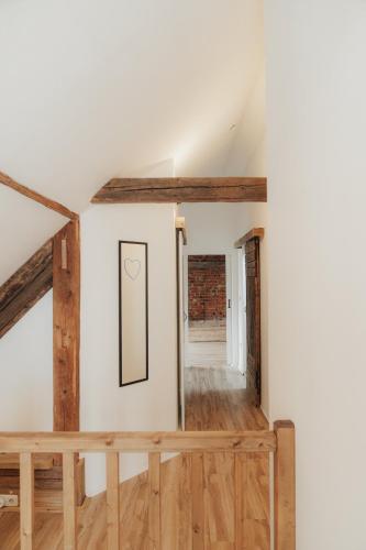 a room with white walls and wooden floors at Südburgenland Vierkanthof in Doiber