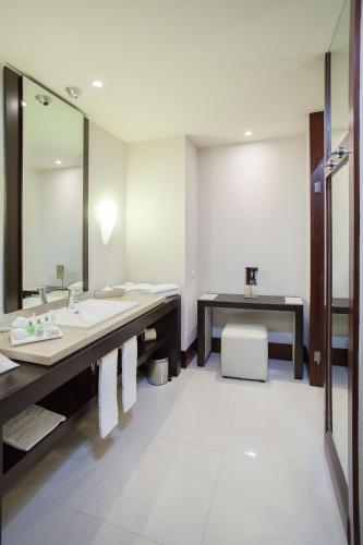 a bathroom with a sink and a mirror at NH Collection Guadalajara Providencia in Guadalajara