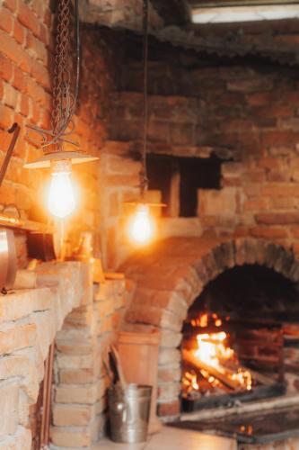 a large brick oven with a fire in it at Südburgenland Vierkanthof in Doiber