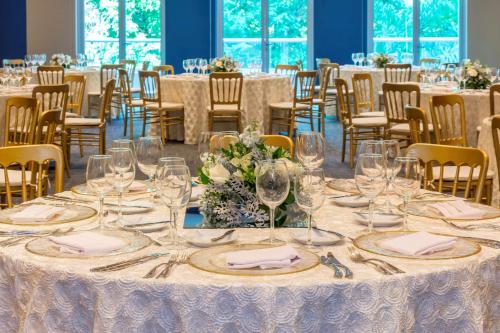 a table set up for a wedding with glasses and napkins at NH Collection Guadalajara Providencia in Guadalajara