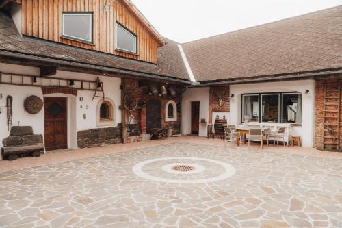 a house with a patio with a table and chairs at Südburgenland Vierkanthof in Doiber