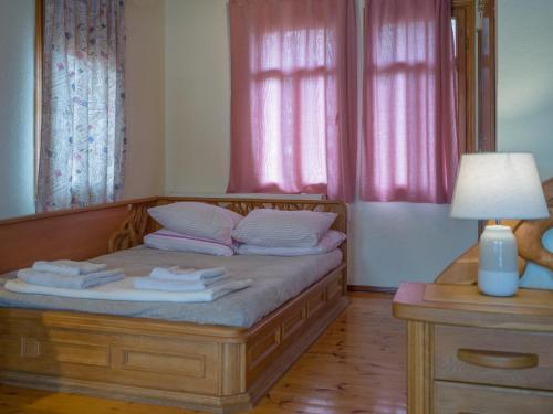 a bedroom with a bed with two towels on it at Prespes Lake View Family Apartment in Florina