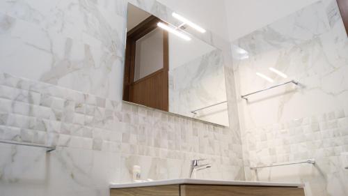 a bathroom with a sink and a mirror at Smart and Sea in Tortoreto Lido