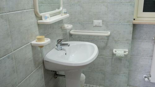 a bathroom with a sink and a toilet at Smart and Sea in Tortoreto Lido