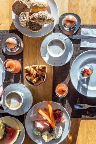 a bunch of plates of food on a table at AlpenParks Hotel & Apartment Sonnleiten in Saalbach Hinterglemm