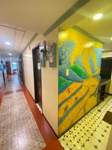 a painting on the wall of a hallway at Park Avenue Boutique Hotel Manila in Manila