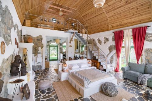 a bedroom with a large bed and a staircase at Country SPA Village in Ciofliceni