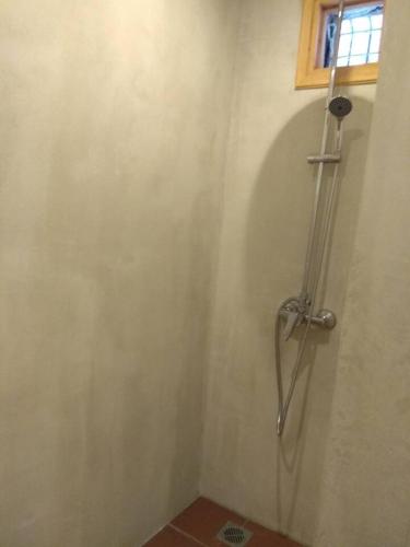 a shower stall in a bathroom with a window at Oνειροπαγίδα in Ayia anna