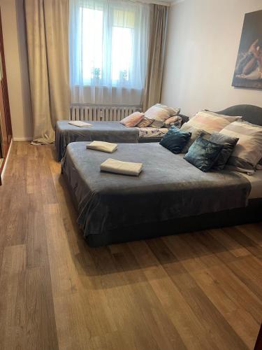 two beds in a bedroom with two towels on them at Apartament Dymińska in Warsaw