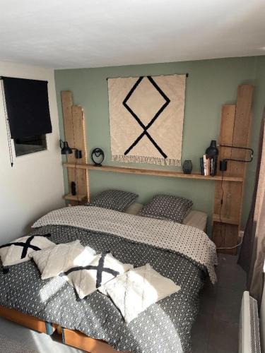 a bedroom with a bed and a flat screen tv at chez Nadège in Floing