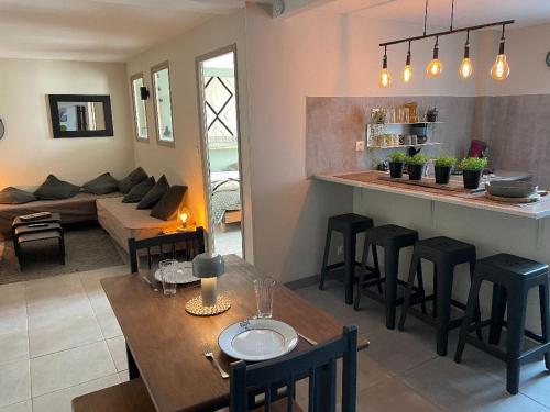 a kitchen and living room with a table and chairs at chez Nadège in Floing