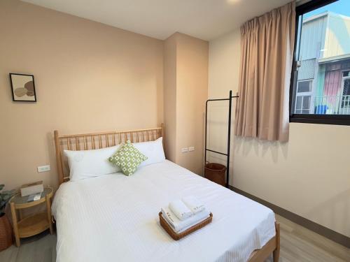 a bedroom with a bed with two towels on it at Lin's House in Ch'ih-k'an-lou