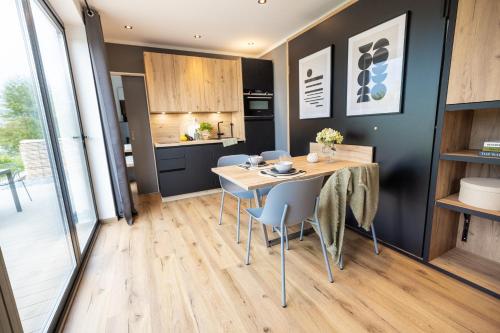 a kitchen and dining room with a table and chairs at Tiny House mit Sauna - am Main in Wipfeld
