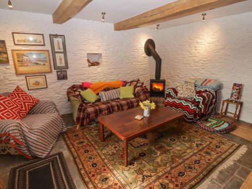 a living room with a couch and a table at Tipyn Bach in Caerphilly