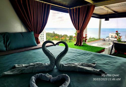 two metal swans making a heart on a bed at Mi Amor Ocean Penthouse - 3 minutes to the beach - Downtown in Phu Quoc