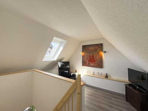 a room with a staircase with a painting on the wall at Großer Hookie in Hooksiel