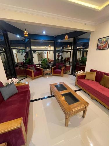 a living room with couches and a coffee table at Summit Embassy in Skardu