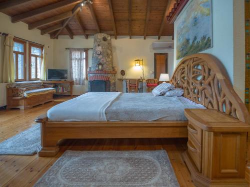 a bedroom with a large bed with a wooden frame at Prespes Lake View Family Apartment in Florina