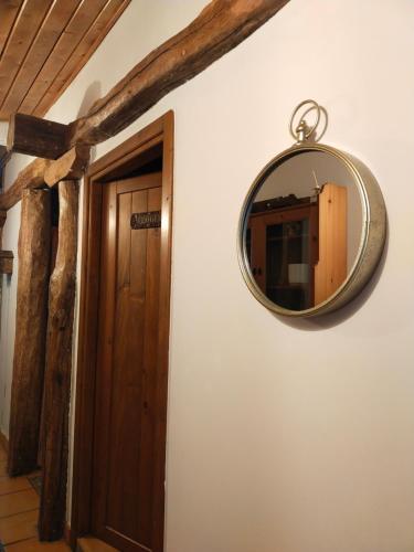 a mirror hanging on a wall next to a door at ANTZOMENDI in Mutriku