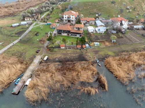 an aerial view of a house on an island in the water at Prespes Lake View Family Apartment in Florina