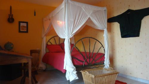 a bedroom with a bed with a canopy at Sepmes - Le Saut du Loup in Sepmes