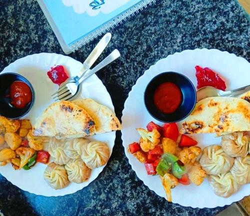 two plates of food on a table with food at Brahma Heritage-Pool with Nature in Pushkar