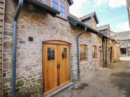 an old stone building with a wooden door at The Hideaway in Bishops Castle