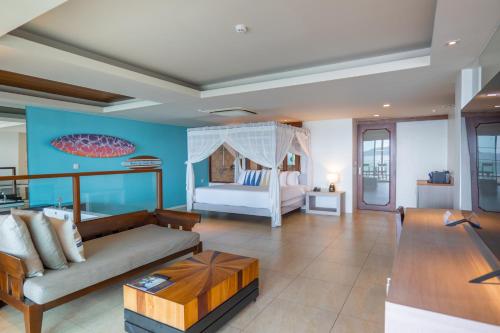 a living room with a bed and a couch at Zenmaya Oceanfront Phuket, Trademark Collection by Wyndham in Patong Beach