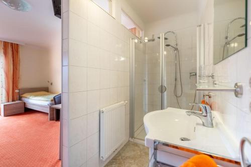 a bathroom with a shower and a sink at RosHof Apartments in Spital am Semmering