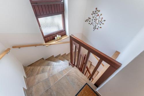a staircase in a house with a window at RosHof Apartments in Spital am Semmering