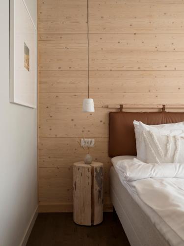 a bedroom with a bed and a lamp on a table at The Wood Hotel by Elite in Skellefteå